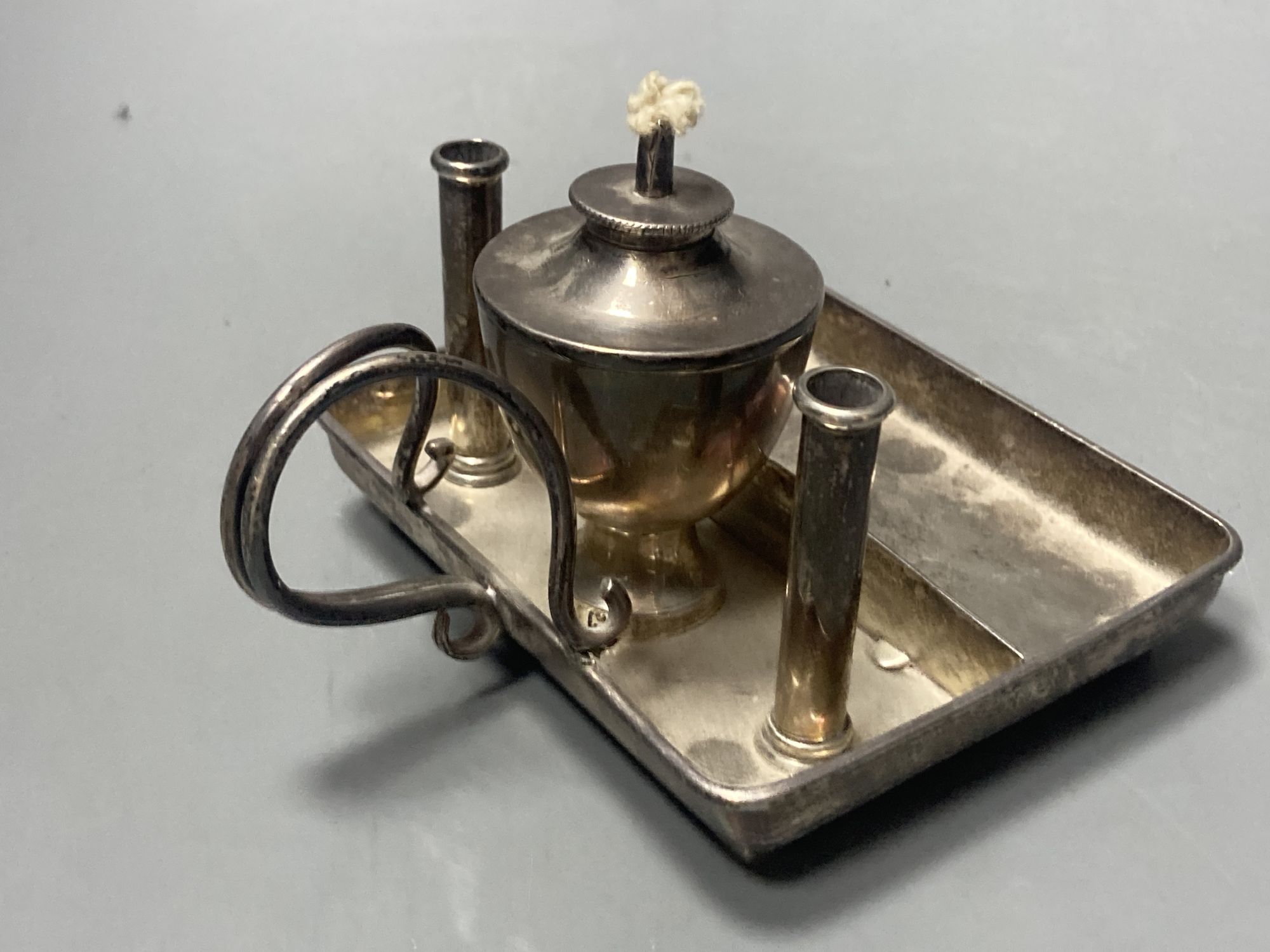 A George V silver square table lighter with wick and two cylindrical compartments (incomplete?), London, 1913, 10.9cm.